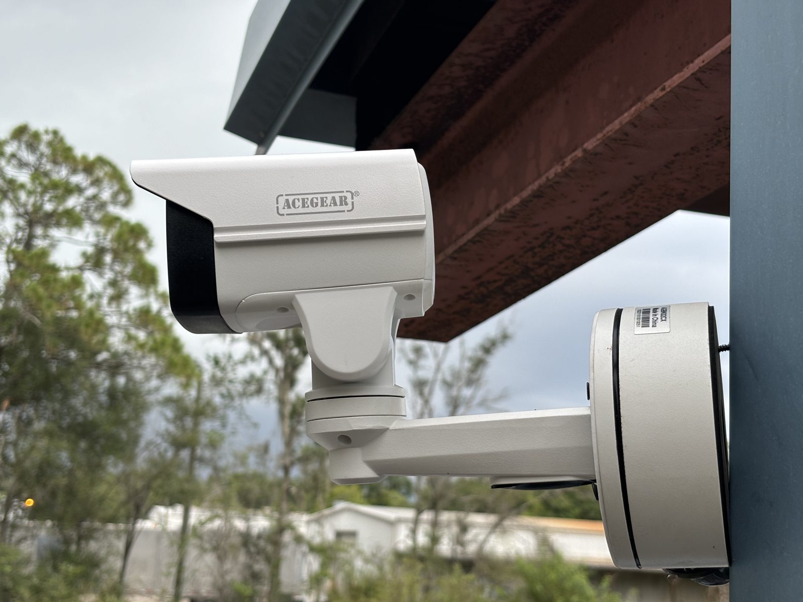 Commercial-grade IP security camera mounted under a building overhang at an Orlando business property